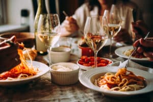 People dining out and enjoying pasta at restaurants in La Crosse, WI